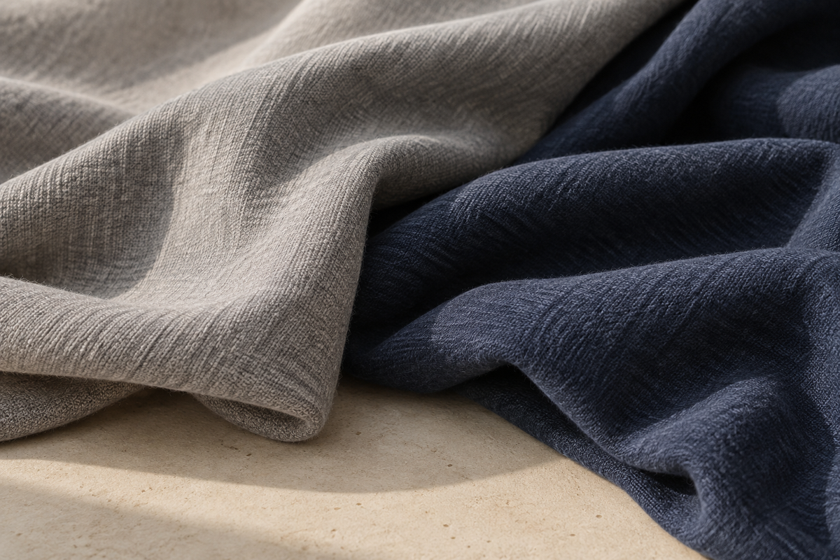 Softly textured stone grey and navy fabric folds in natural light