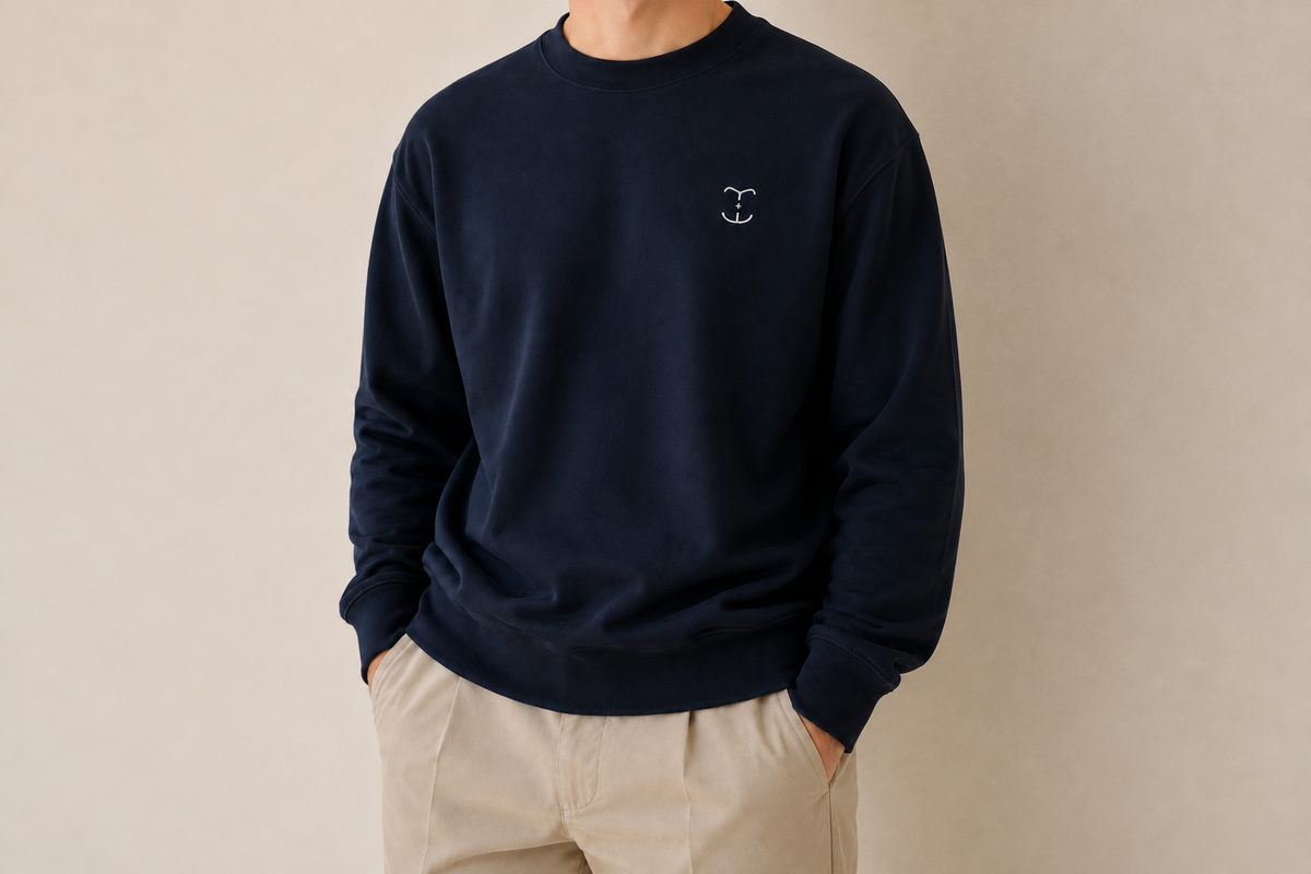 Face free view of a navy TELLS sweatshirt with a small white embroidered chest mark