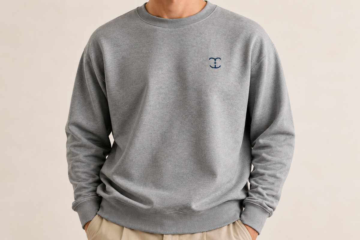 Grey TELLS crew neck sweatshirt shown from the neck downward against a pale background