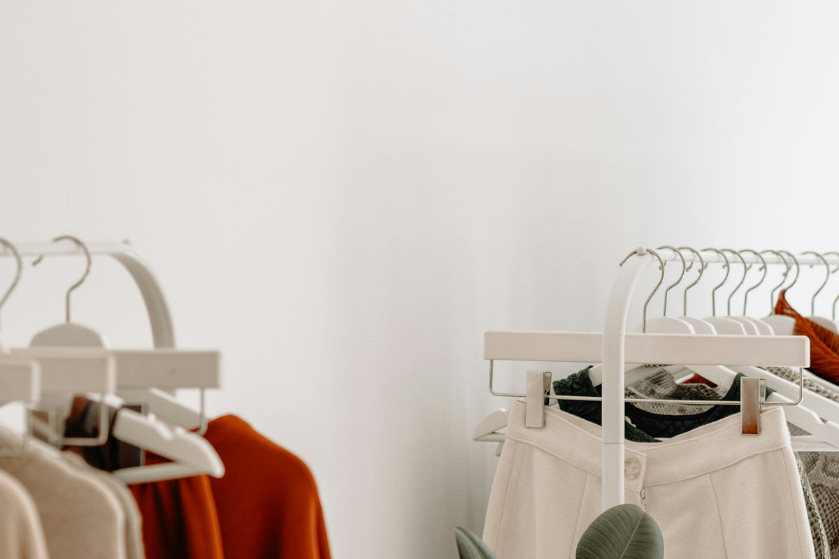 Racks of neutral-toned clothing in a shop, photographed by Thom Bradley; illustrative image, not the eBay runway
