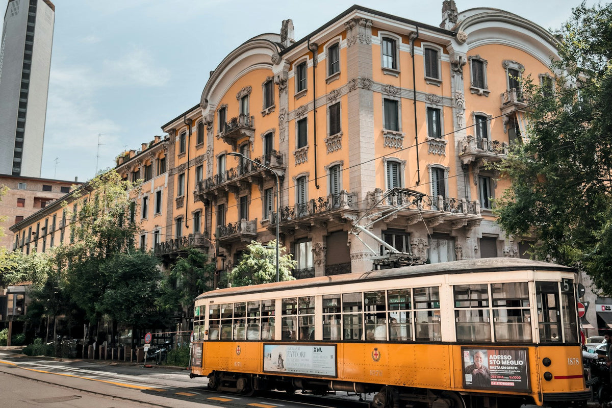 Historic yellow tram on a Milan street in early autumn