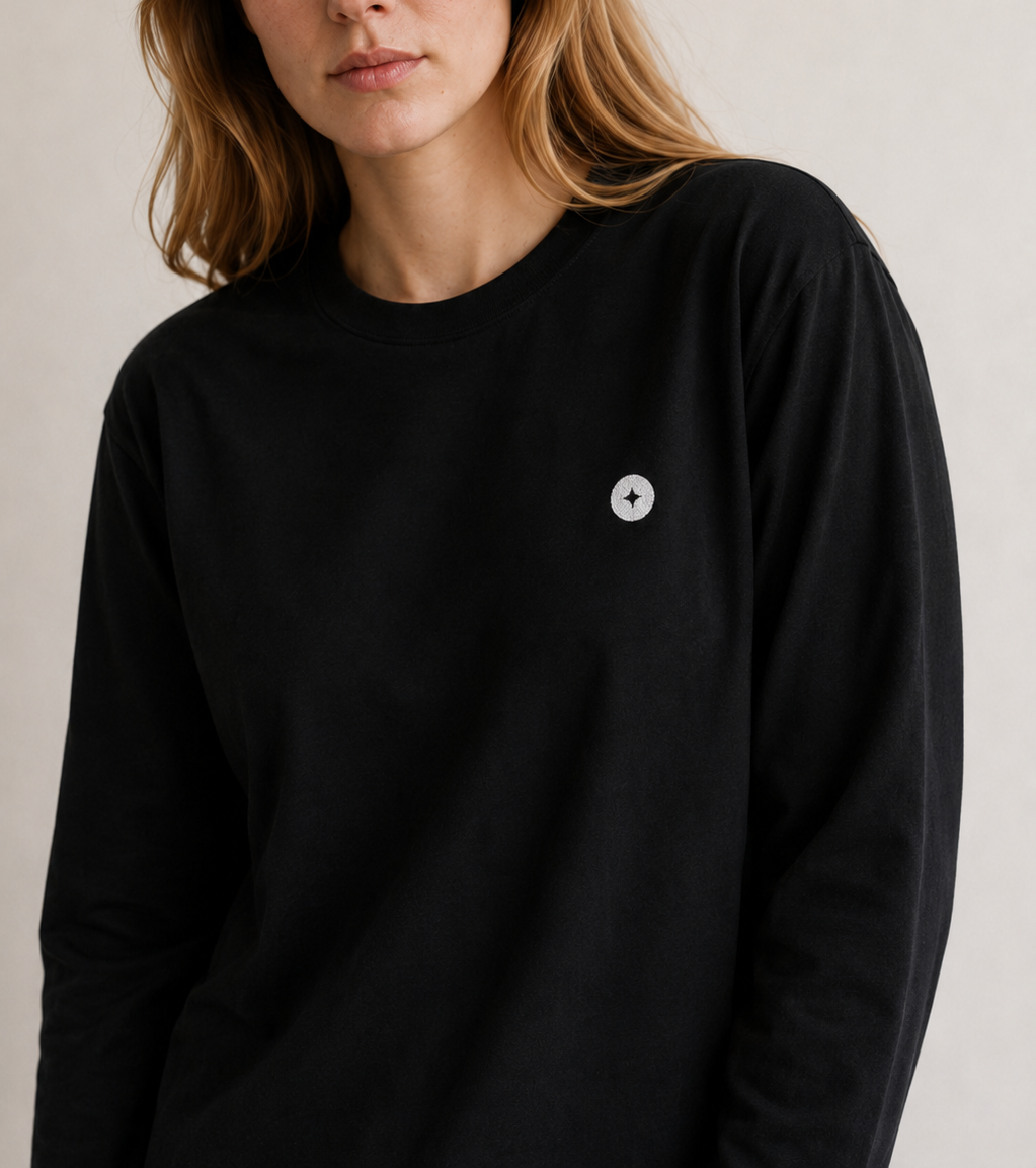 Woman wearing a black TELLS long sleeve T shirt as an autumn concert base layer
