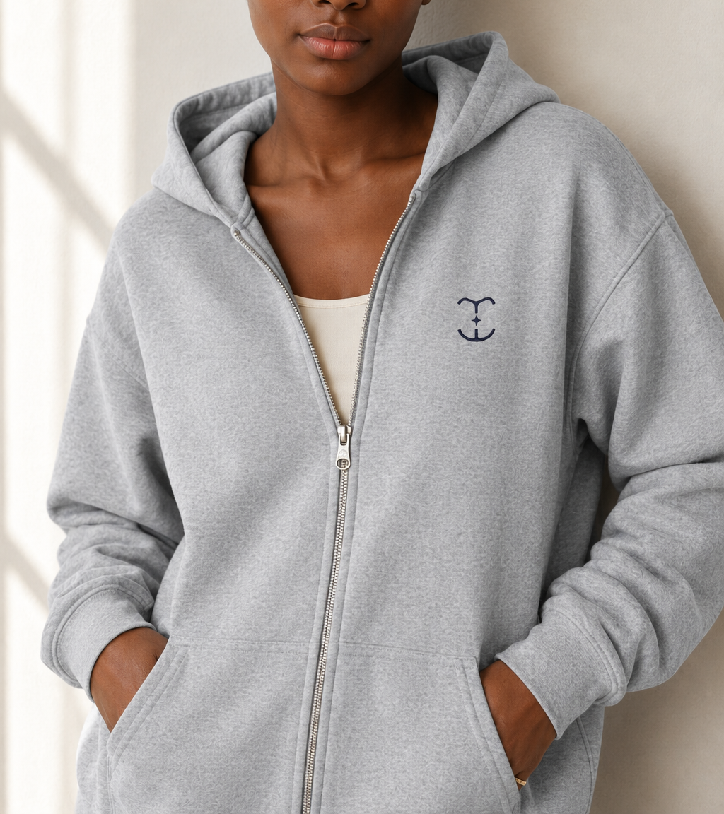 TELLS gray zip-up hoodie showing the front zip and relaxed fit