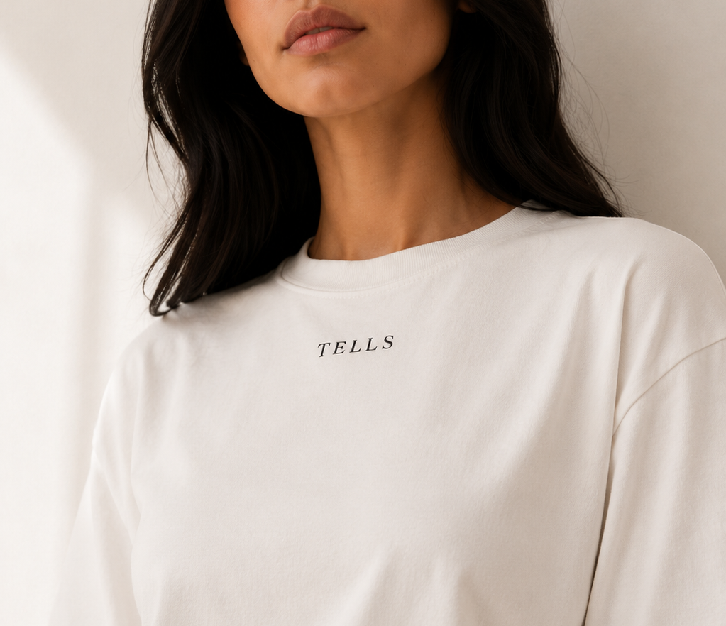 Woman wearing a white TELLS boxy T shirt with a clean crew neckline