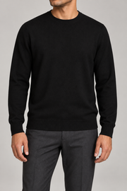 Front studio view of Still Hours Crewneck Sweater in Black, showing the plain knit body and crew neckline.