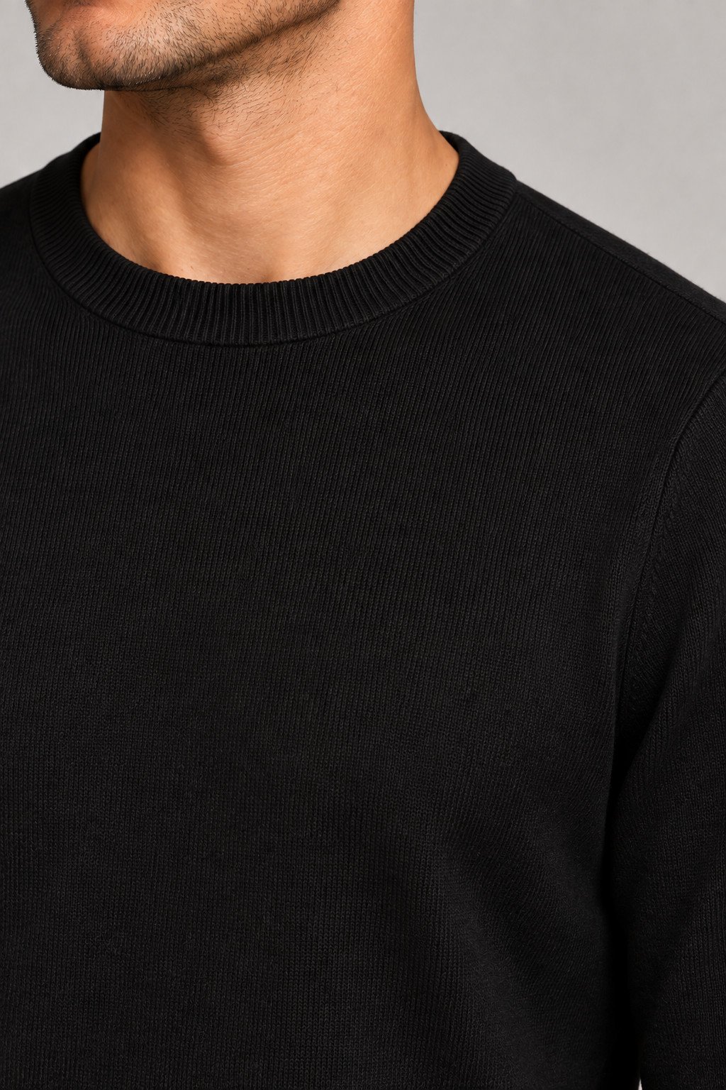 Close-up of Still Hours Crewneck Sweater in Black, showing the fine knit texture and ribbed crew neckline.