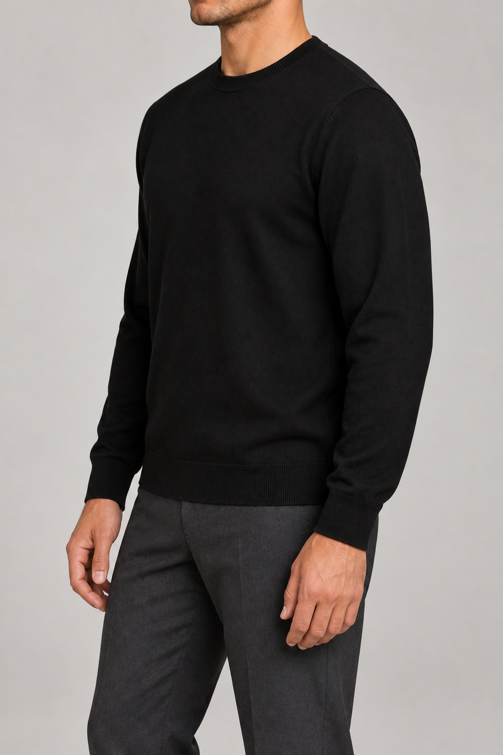 Three-quarter studio view of Still Hours Crewneck Sweater in Black, showing the plain silhouette and long sleeves.