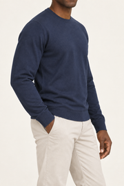 Three-quarter studio view of Still Hours Crewneck Sweater in Navy, showing the classic silhouette and solid Navy finish.