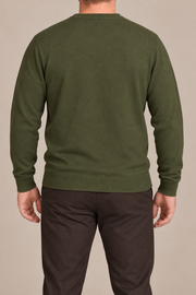Rear studio view of Still Hours Crewneck Sweater in Olive, showing the unadorned back and long sleeves.