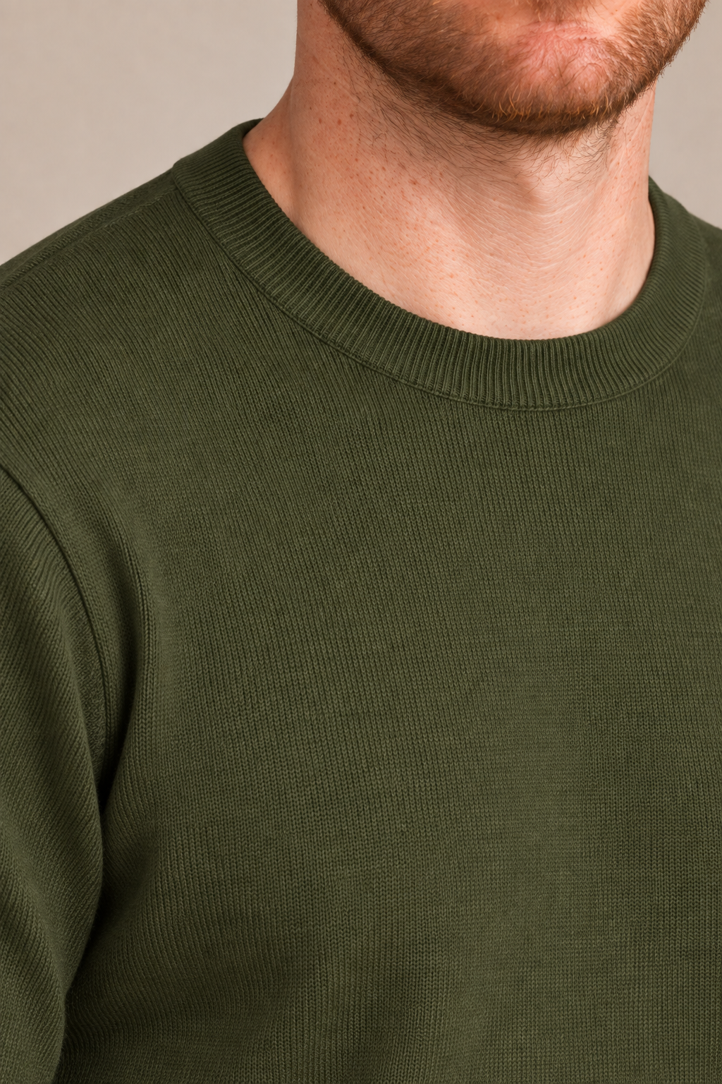 Neckline close-up of Still Hours Crewneck Sweater in Olive, showing the fine Olive knit texture and ribbed collar.