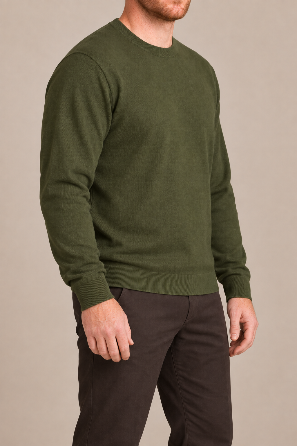 Three-quarter studio view of Still Hours Crewneck Sweater in Olive, showing the classic silhouette and solid Olive finish.