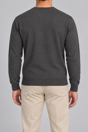 Rear studio view of Still Hours Crewneck Sweater in Charcoal, showing the unadorned back and long sleeves.