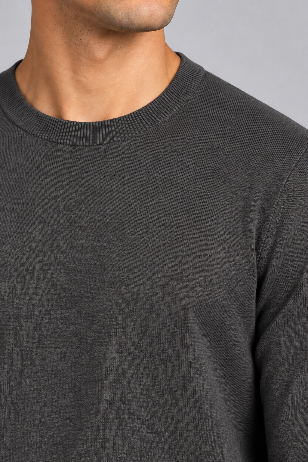 Neckline close-up of Still Hours Crewneck Sweater in Charcoal, showing the fine Charcoal knit texture and ribbed collar.