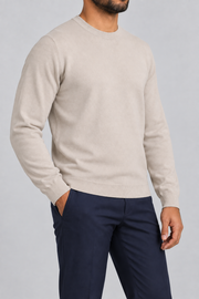 Three-quarter studio view of Still Hours Crewneck Sweater in Sand, showing the classic silhouette and solid Sand finish.