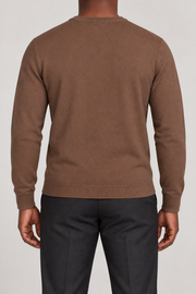 Rear studio view of Still Hours Crewneck Sweater in Toffee, showing the unadorned back and long sleeves.