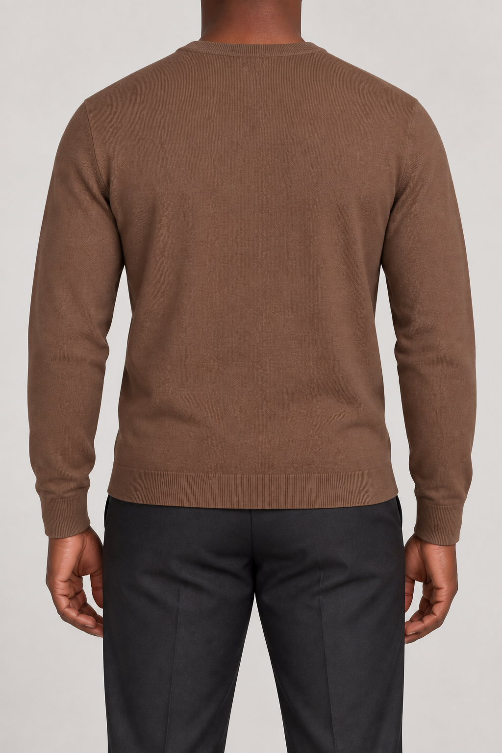 Rear studio view of Still Hours Crewneck Sweater in Toffee, showing the unadorned back and long sleeves.
