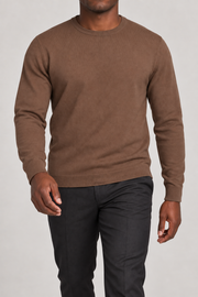 Walking studio view of Still Hours Crewneck Sweater in Toffee, showing the natural drape of the plain knit.