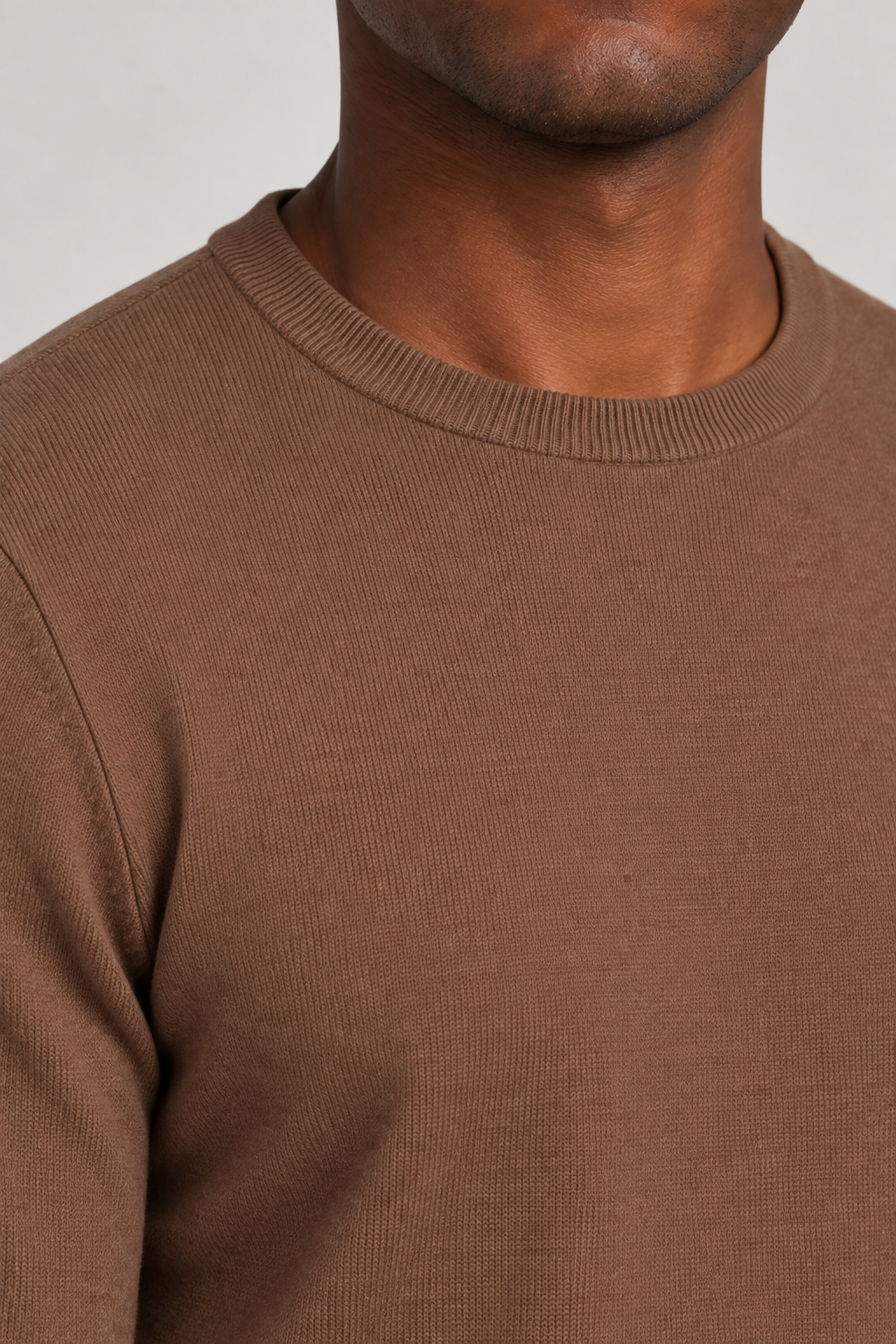 Neckline close-up of Still Hours Crewneck Sweater in Toffee, showing the fine Toffee knit texture and ribbed collar.