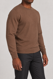 Three-quarter studio view of Still Hours Crewneck Sweater in Toffee, showing the classic silhouette and solid Toffee finish.