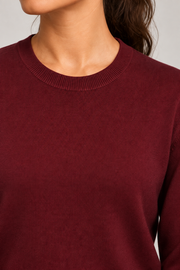 Close-up neckline detail of Quiet Form Crewneck Sweater in Burgundy, showing the fine knit and ribbed crew collar.