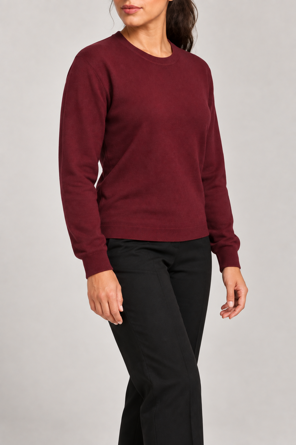 Three-quarter studio view of Quiet Form Crewneck Sweater in Burgundy, showing the long sleeves and classic silhouette.