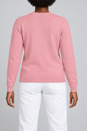 Rear studio view of Quiet Form Crewneck Sweater in Pink, showing the plain back and ribbed hem.
