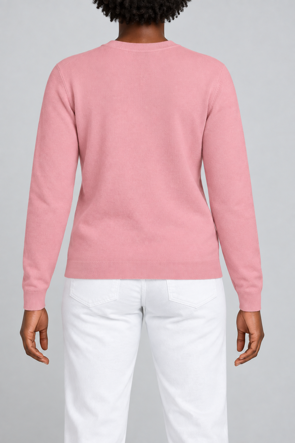 Rear studio view of Quiet Form Crewneck Sweater in Pink, showing the plain back and ribbed hem.