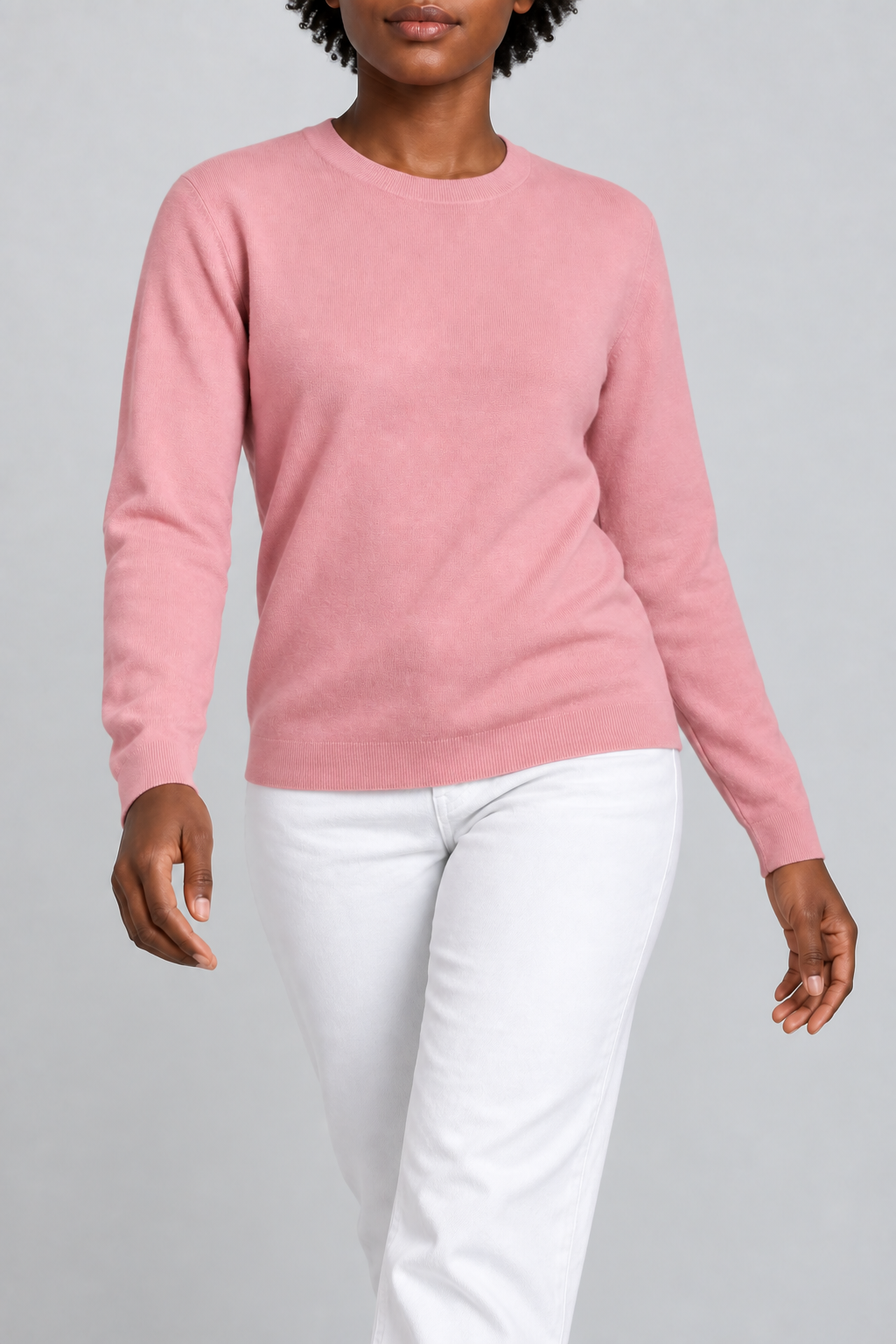 Walking studio view of Quiet Form Crewneck Sweater in Pink, showing the natural knit drape.