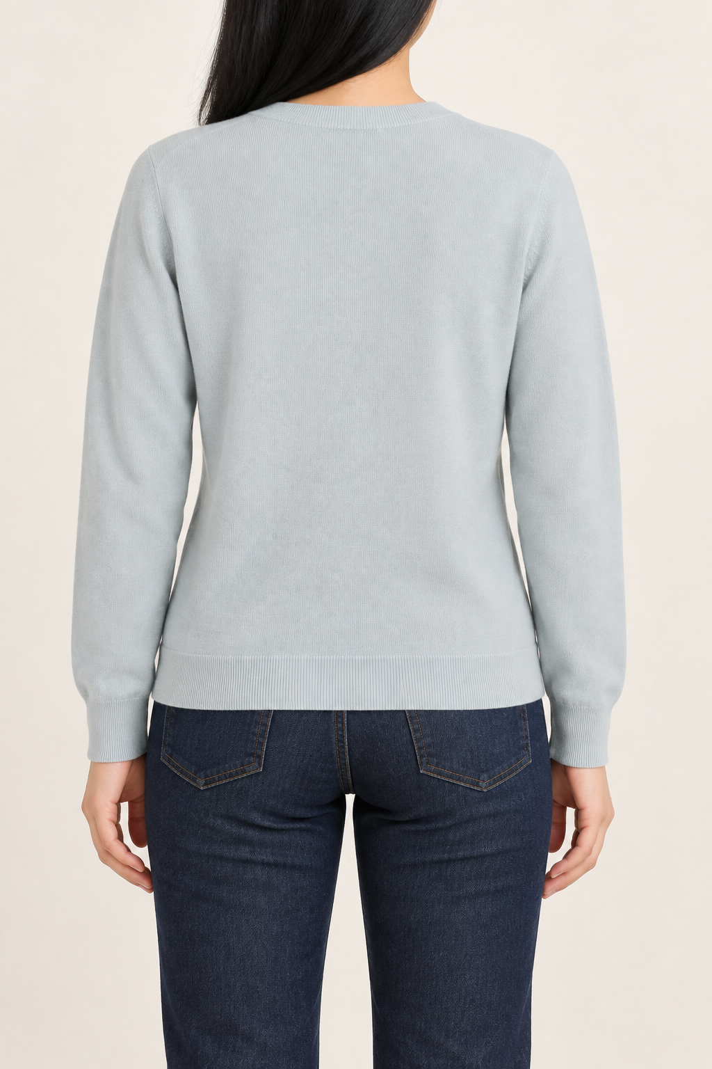 Rear studio view of Quiet Form Crewneck Sweater in Powder, showing the plain back and ribbed hem.