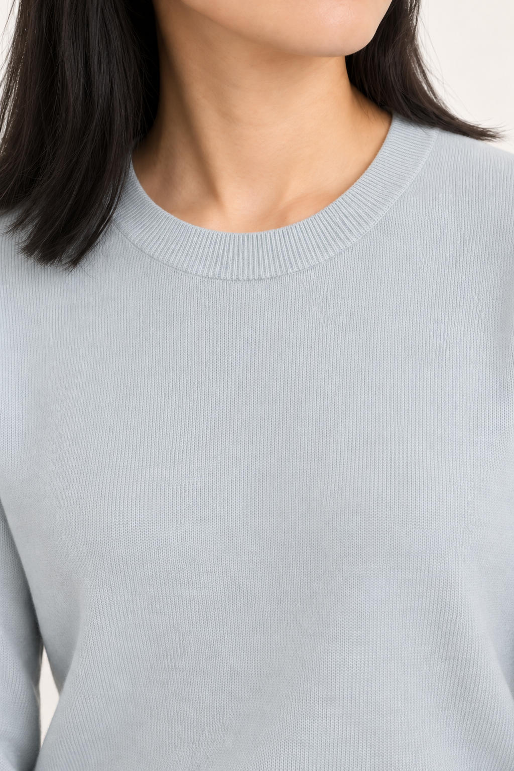 Close-up neckline detail of Quiet Form Crewneck Sweater in Powder, showing the fine knit and ribbed crew collar.