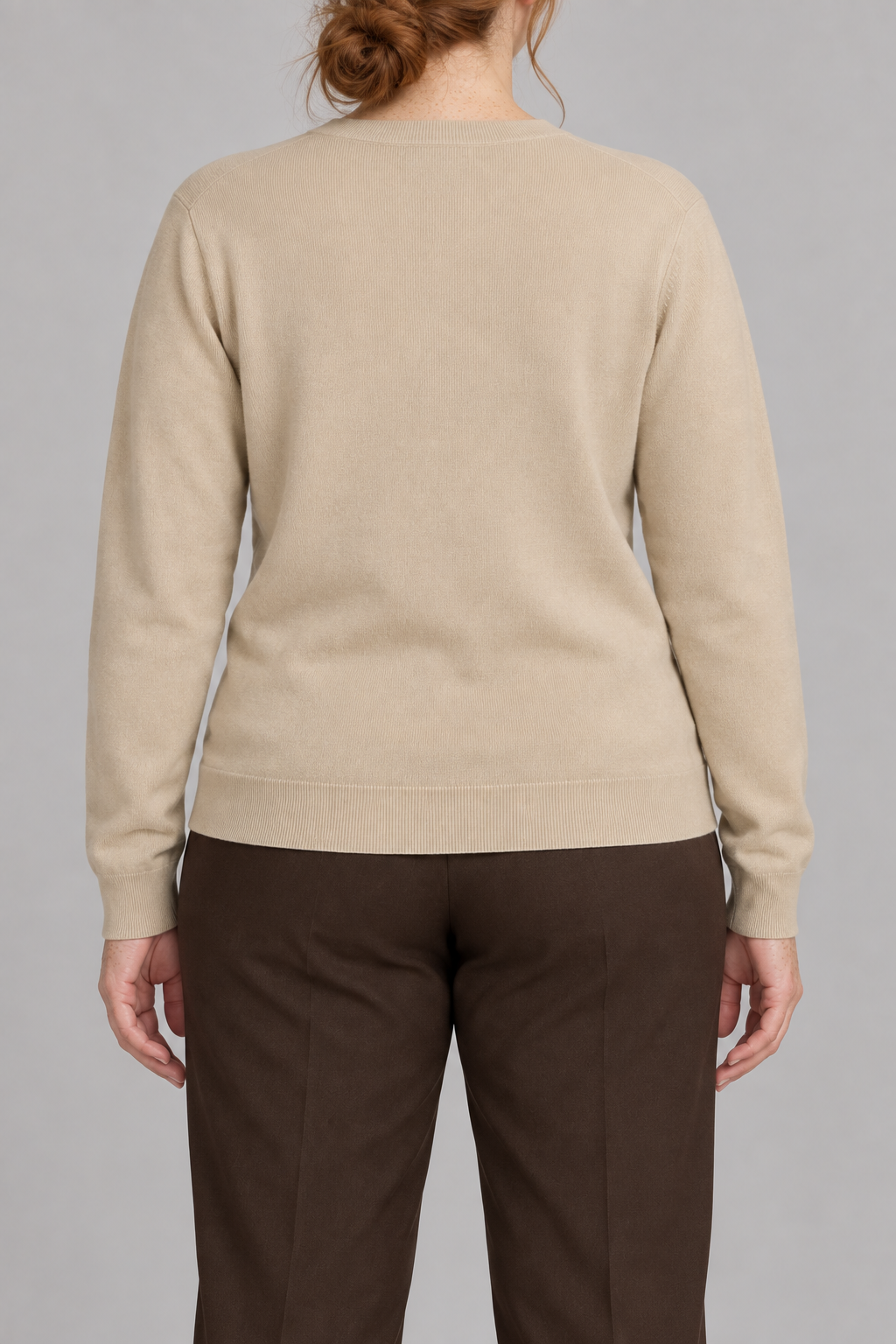 Rear studio view of Quiet Form Crewneck Sweater in Beige, showing the plain back and ribbed hem.