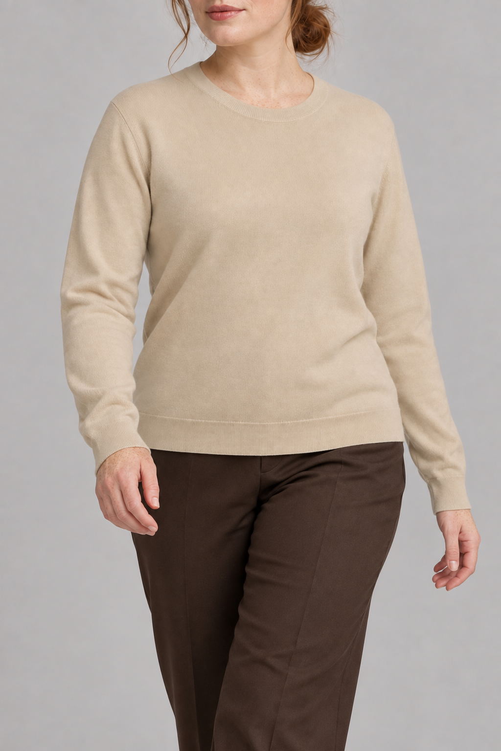 Walking studio view of Quiet Form Crewneck Sweater in Beige, showing the natural knit drape.