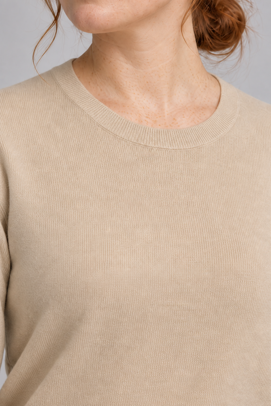 Close-up neckline detail of Quiet Form Crewneck Sweater in Beige, showing the fine knit and ribbed crew collar.