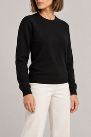 Three-quarter studio view of Quiet Form Crewneck Sweater in Black, showing the long sleeves and classic silhouette.