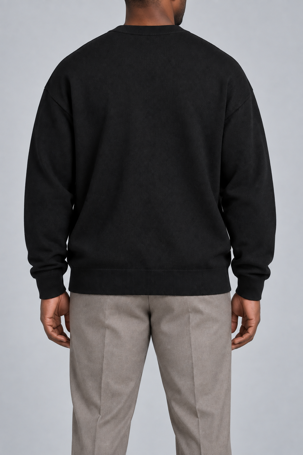 Rear studio view of Slow Days Relaxed Crewneck in Black, showing the plain back and ribbed hem.