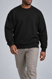 Walking studio view of Slow Days Relaxed Crewneck in Black, showing the natural knit drape.
