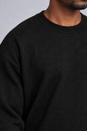 Close-up neckline detail of Slow Days Relaxed Crewneck in Black, showing the fine knit and ribbed crew collar.