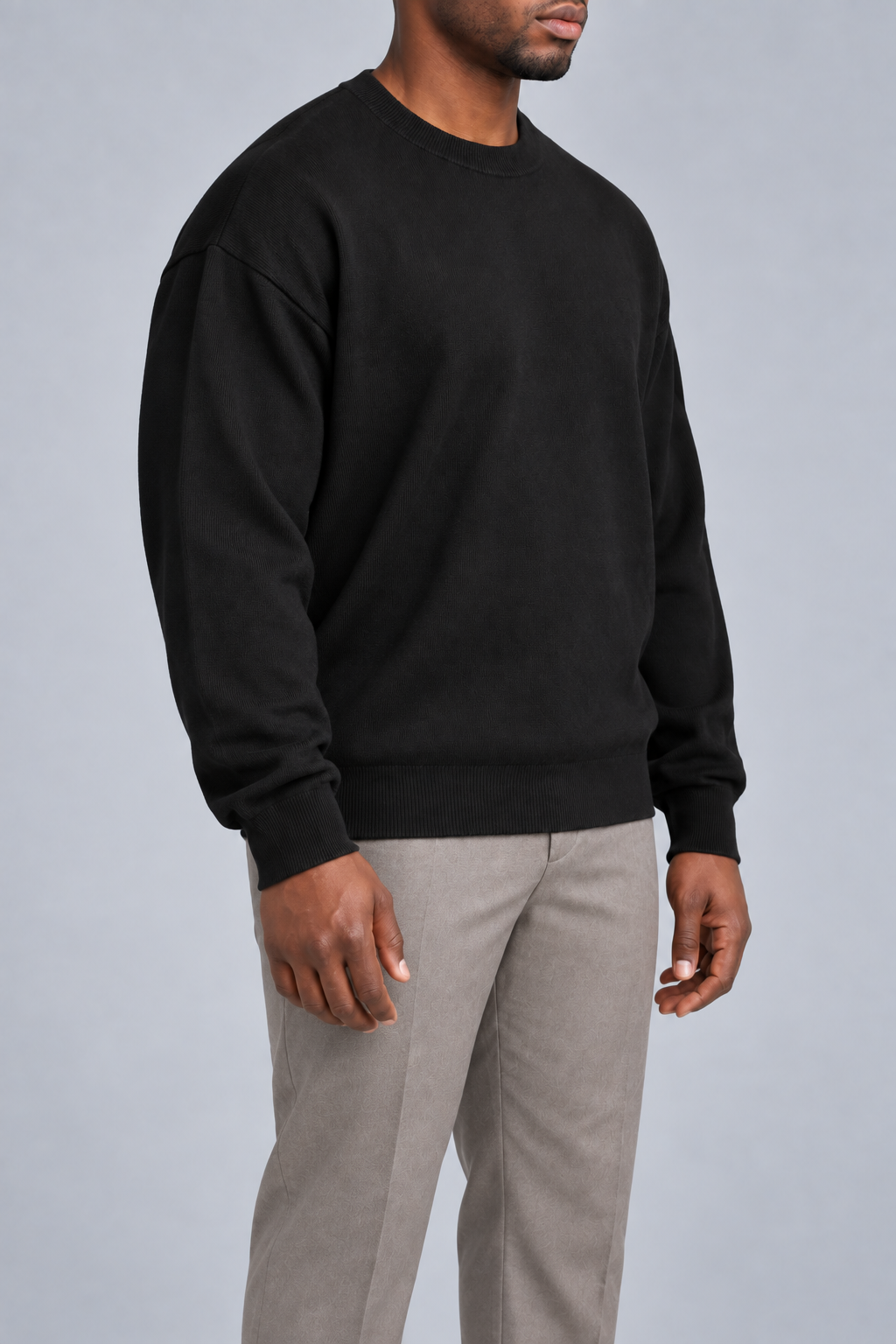Three-quarter studio view of Slow Days Relaxed Crewneck in Black, showing the dropped shoulders and roomy silhouette.