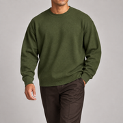 Slow Days Relaxed Crewneck in Olive. Natural movement studio view showing the olive sweater drape.