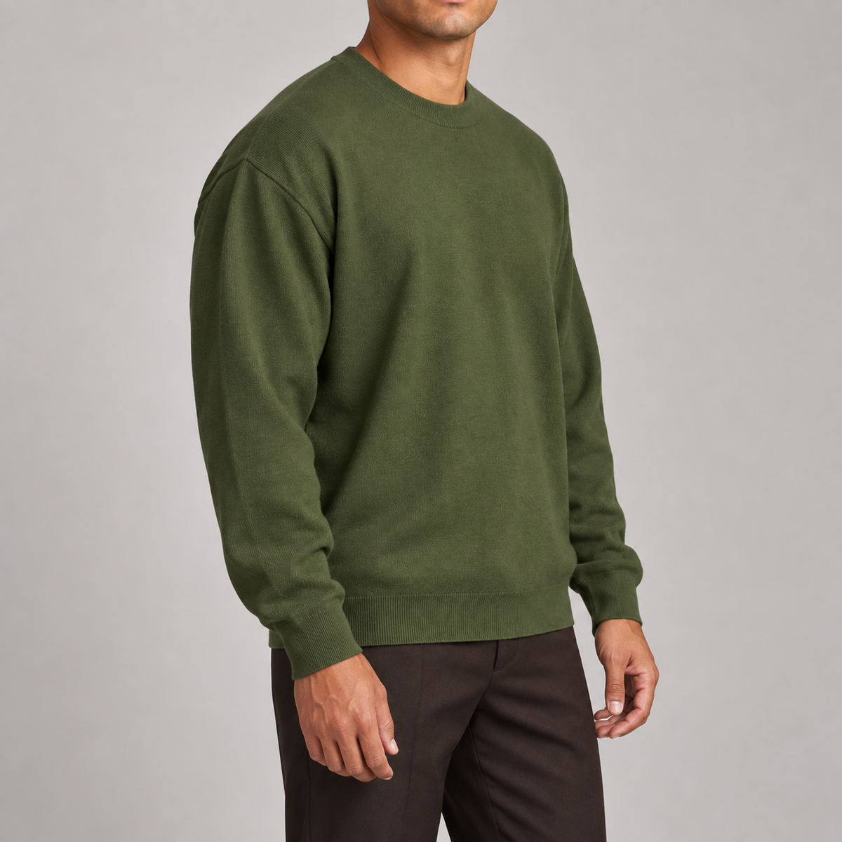 Slow Days Relaxed Crewneck in Olive. Three-quarter studio view showing the olive sweater relaxed shape.