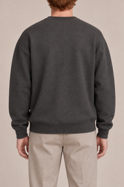 Slow Days Relaxed Crewneck in Charcoal. Rear view of the plain charcoal back and ribbed hem.