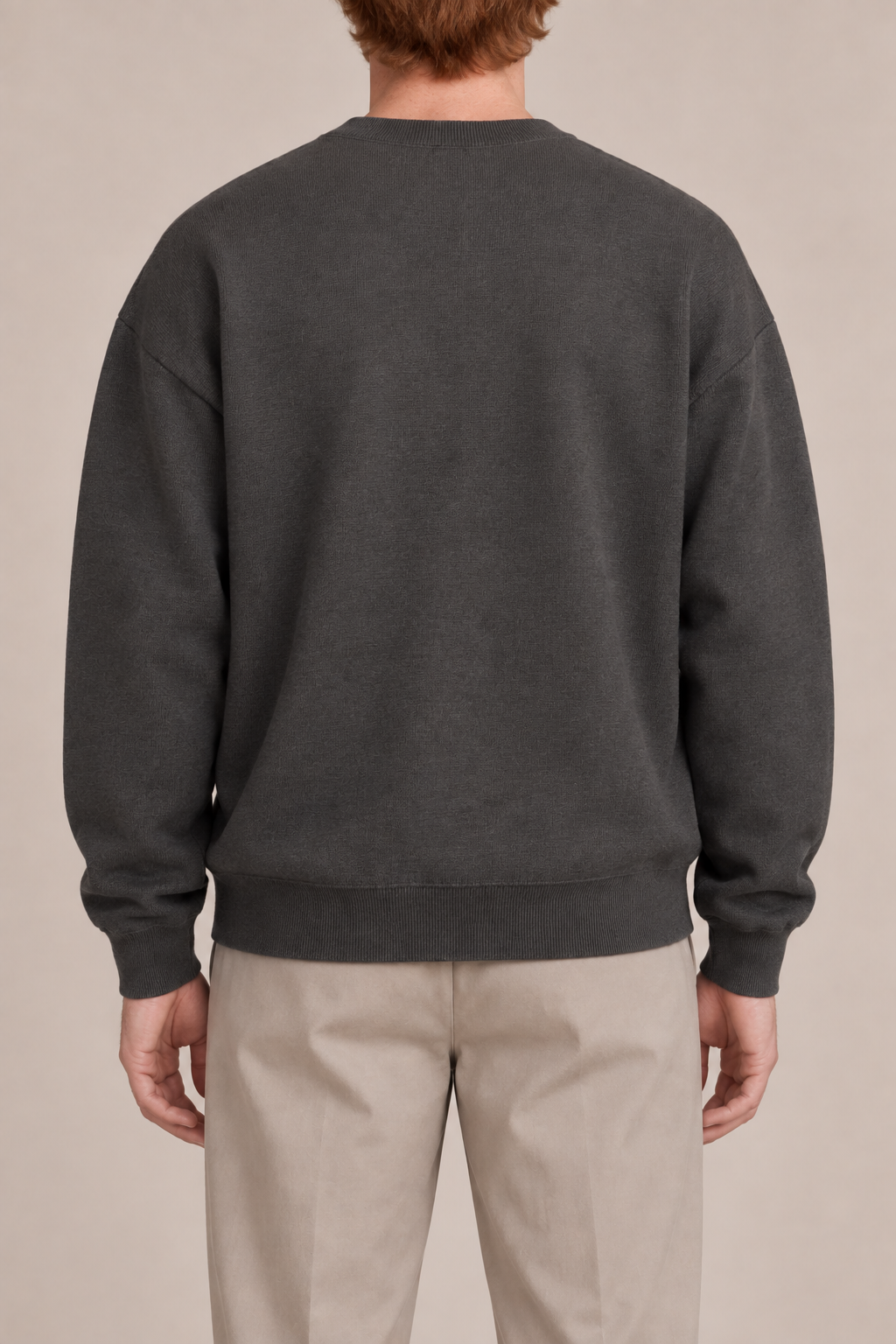 Slow Days Relaxed Crewneck in Charcoal. Rear view of the plain charcoal back and ribbed hem.