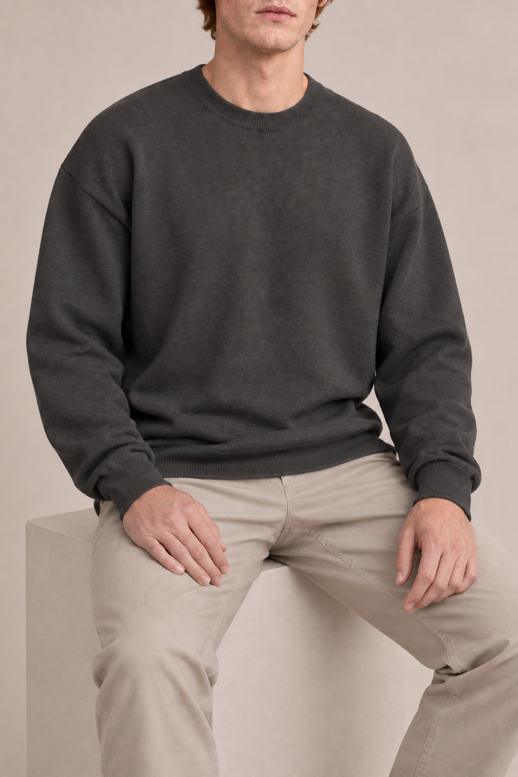 Slow Days Relaxed Crewneck in Charcoal. Seated view showing the charcoal sweater natural drape.