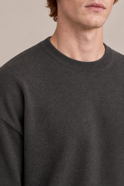 Slow Days Relaxed Crewneck in Charcoal. Close-up of charcoal knit texture and ribbed crew neckline.