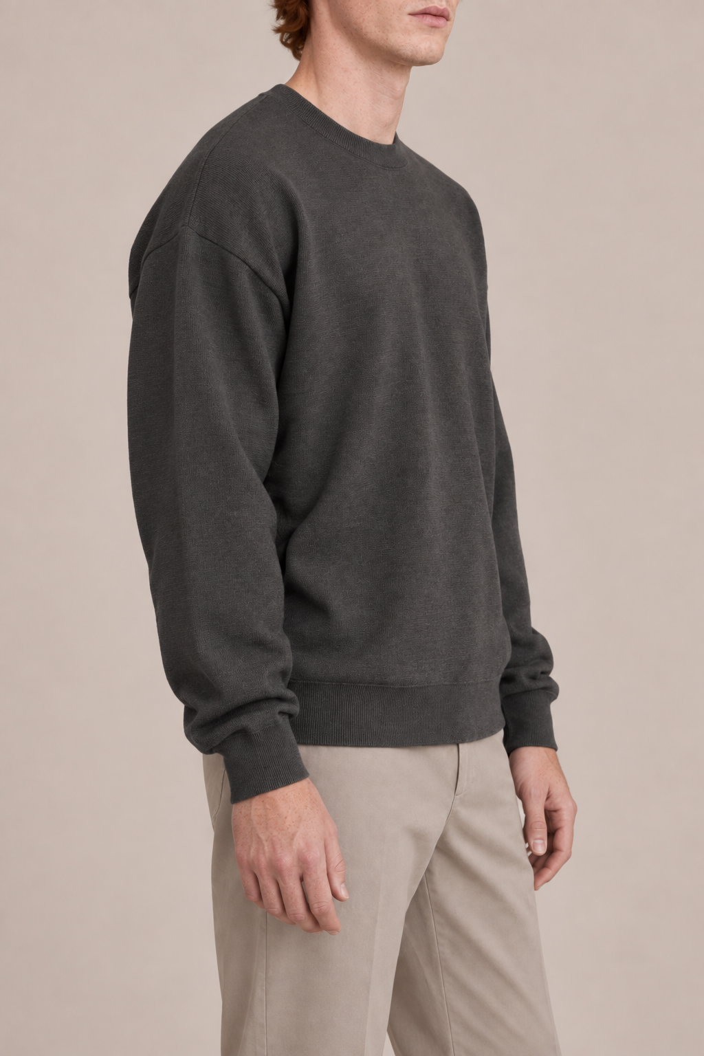 Slow Days Relaxed Crewneck in Charcoal. Side view showing the charcoal sweater relaxed silhouette.