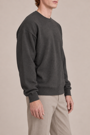 Slow Days Relaxed Crewneck in Charcoal. Side view showing the charcoal sweater relaxed silhouette.