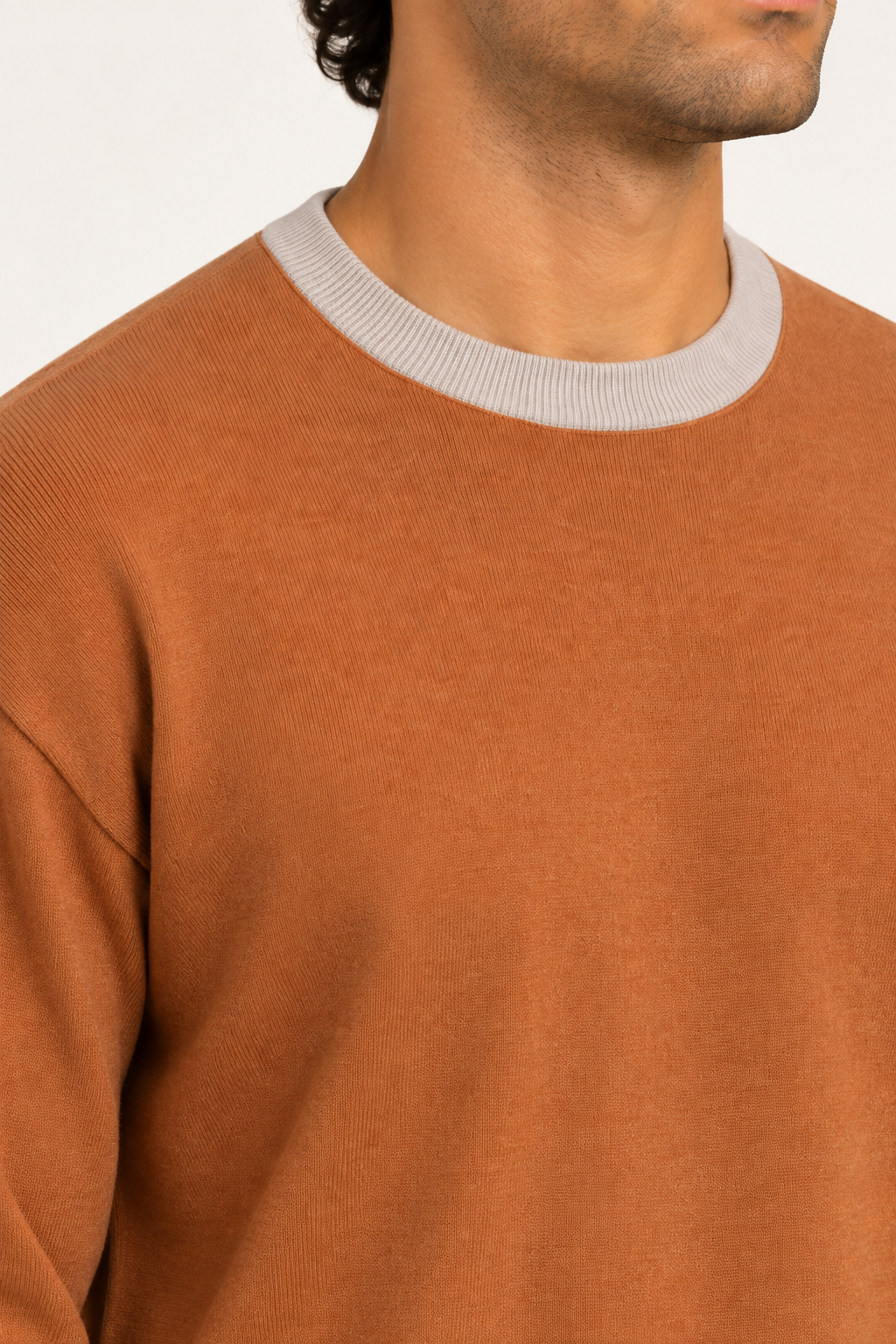 Slow Days Relaxed Crewneck in Rust with Coco Trim. Close-up showing the fine Rust knit and Coco ribbed crew neckline.