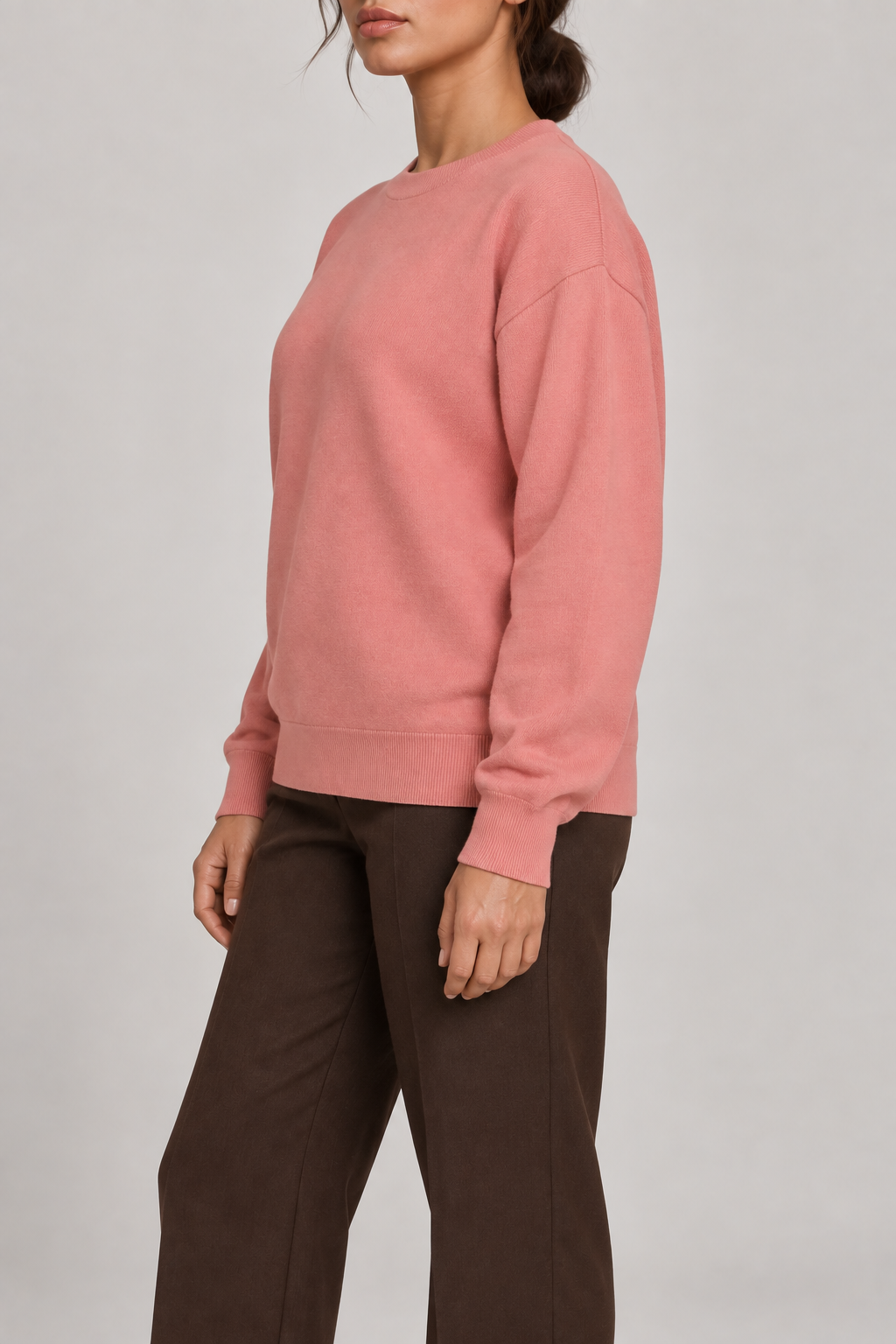 Soft Pause Relaxed Crewneck in Coral. Side view showing the relaxed Coral shape and matching cuffs and hem.