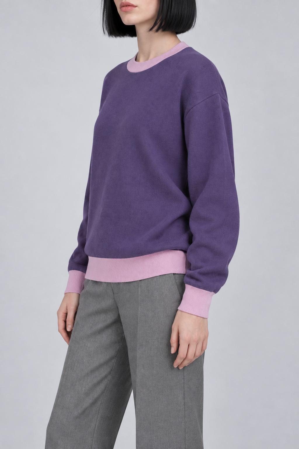 Soft Pause Relaxed Crewneck in Violet with Lilac Trim. Three-quarter view showing the relaxed Violet shape and Lilac trim.
