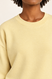 Soft Pause Relaxed Crewneck in Mellow. Close-up showing the fine Mellow knit and ribbed crew neckline.